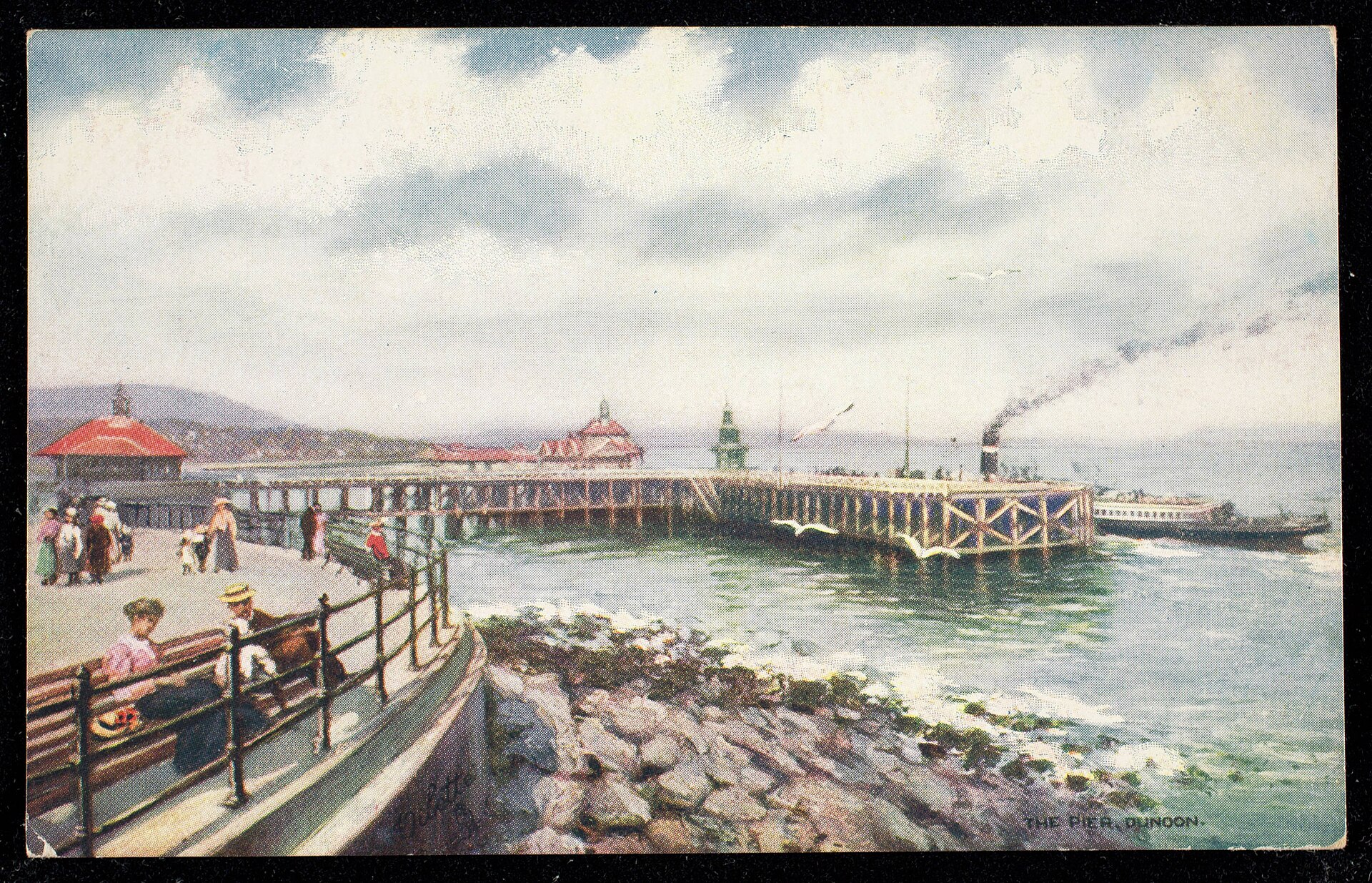 Wide view of Dunoon Pier from the esplanade with a paddle steamer alongside.